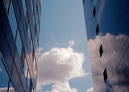 cloud and blue sky reflected in building windows