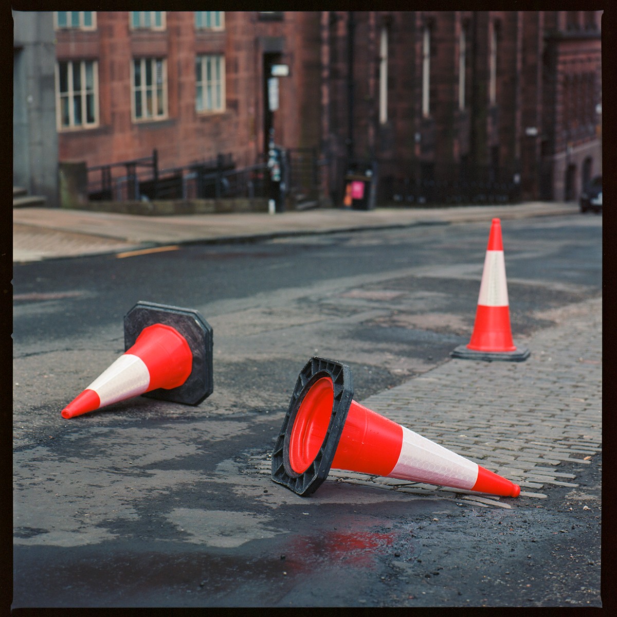 Three road cones on a road