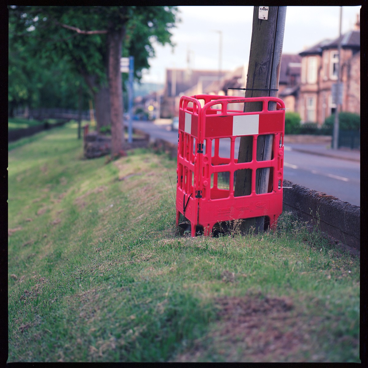 Colour photograph of control barrier and telegraph pole
